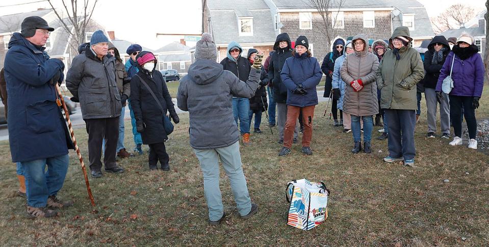 Maura O'Gara leads a winter solstice walking tour for the Quincy Environmental Treasures Program on Thursday Dec. 21, 2023. The tour included the Sailors Snug Harbor Cemetery where Capt. Hanson Gregory, inventor of the doughnut, is buried.