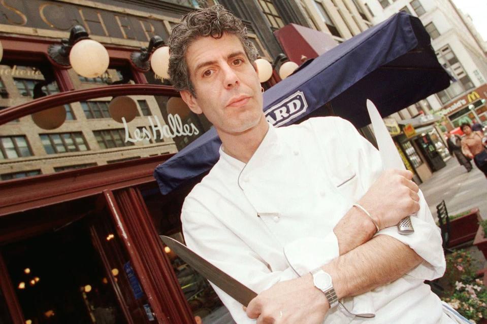 <p>Bourdain outside New York's Les Halles restaurant on May 15, 2000, two years after he became executive chef at the French bistro. In 2000, Bourdain's memoir, <em>Kitchen Confidential</em>, was published. It became a bestseller and launched him into the spotlight. </p>