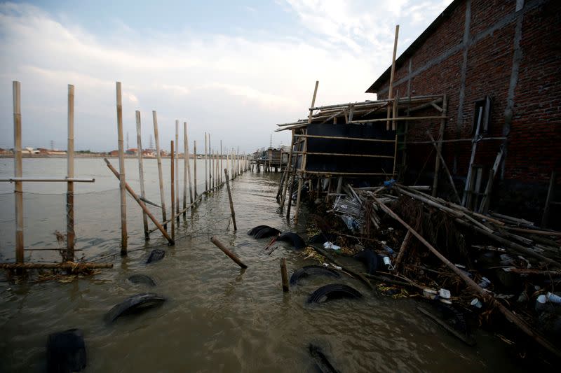 Bamboo sticks and nets for barrier are pictured at Tambakrejo village, where affected by rising sea level and land subsidence, in Semarang