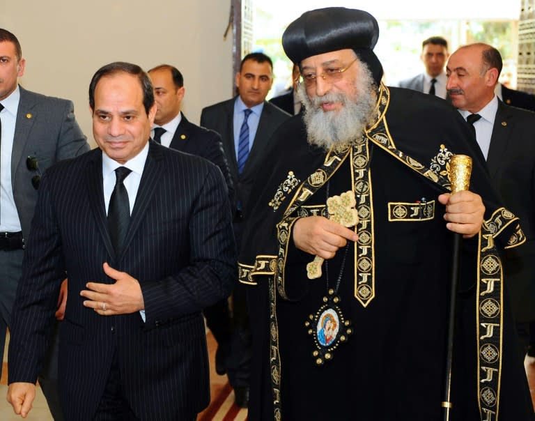 A handout picture released by the president's office on April 13, 2017 shows Egyptian President Abdel Fattah al-Sisi (L) offering his condolences to Coptic Pope Tawadros II at the headquarters of St. Mark's Coptic Orthodox Cathedral in Cairo