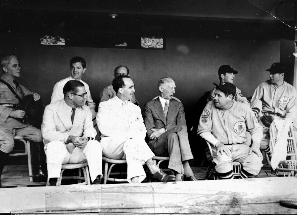 Governor-General of the Philippines, Frank Murphy, a former mayor of Detroit, sits with ballplayers when Babe Ruth brought his American League players on a barnstorming tour to Manila in 1935. Murphy is shown in the dugout chatting with Connie Mack and Ruth.