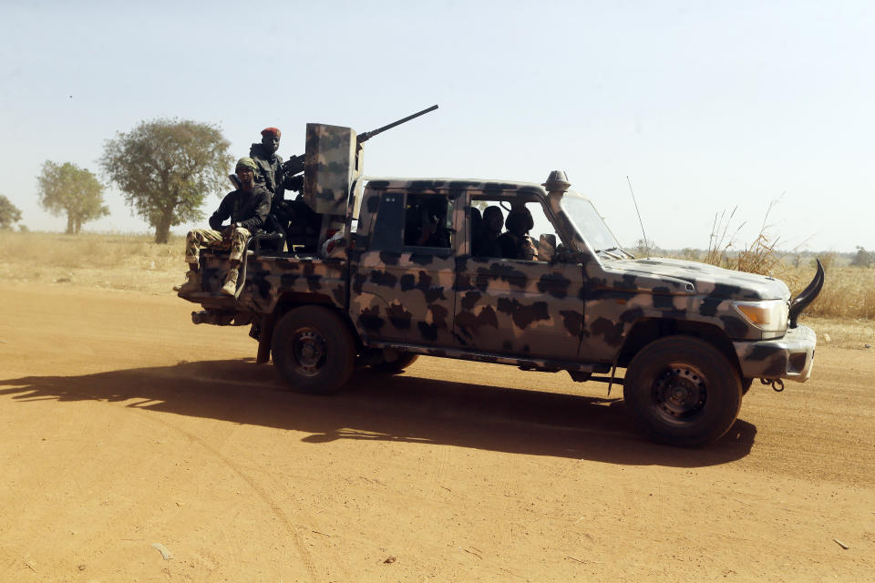 Nigerian soldiers drive past Government Science secondary school in Kankara , Nigeria, Wednesday, Dec. 16, 2020. Rebels from the Boko Haram extremist group claimed responsibility Tuesday for abducting hundreds of boys from a school in Nigeria's northern Katsina State last week in one of the largest such attacks in years, raising fears of a growing wave of violence in the region. (AP Photo/Sunday Alamba)