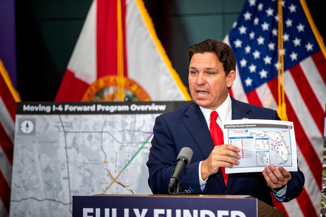 Florida Gov. Ron DeSantis holds a graphic depicting future road construction work as he spoke about transportation improvements on Interstate 4 during a press conference held at Florida Polytechnic University in Lakeland, Wednesday, April 3, 2024.