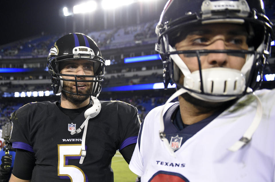 Perhaps Joe Flacco (L) got more words out of Tom Savage than the media did on Monday night. (AP) 