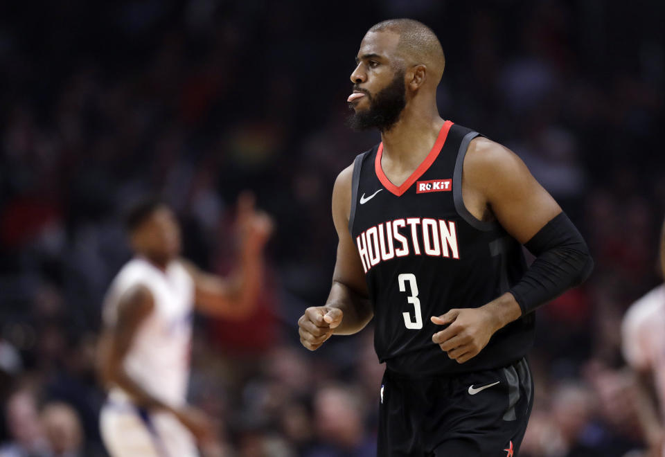 Houston Rockets' Chris Paul reacts after making a 3-point basket against the Los Angeles Clippers during the first half of an NBA basketball game Wednesday, April 3, 2019, in Los Angeles. (AP Photo/Marcio Jose Sanchez)