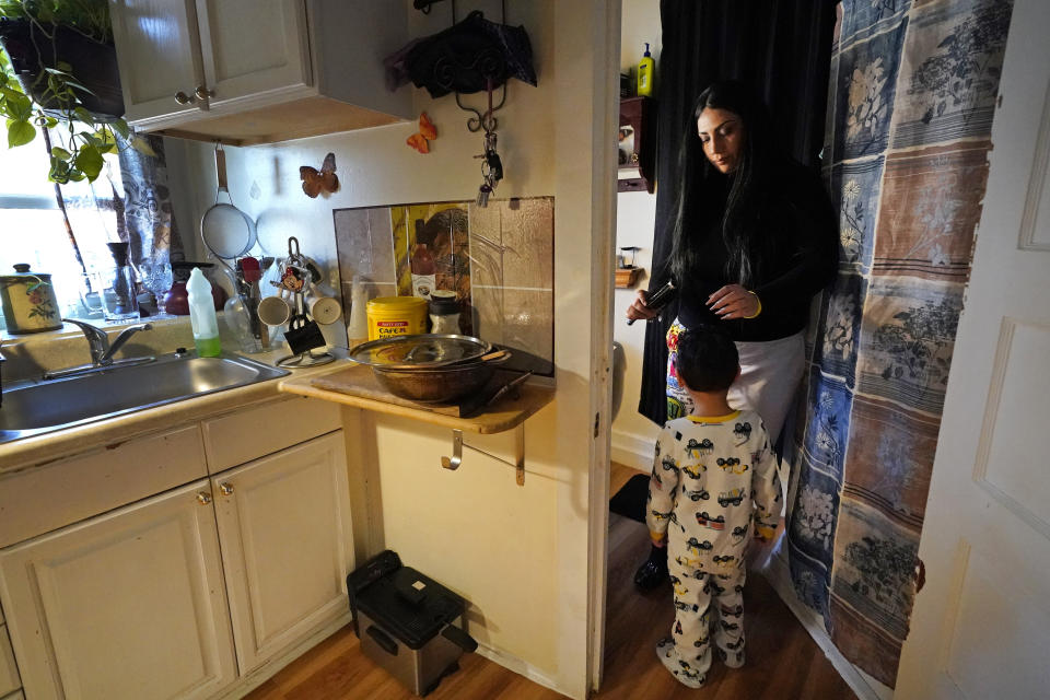 Isabel Miranda brushes the hair of her 4-year-old son, Julian, Wednesday, March 10, 2021, in their rental apartment in Haverhill, Mass. The Biden administration is extending a federal moratorium on evictions of tenants who've fallen behind on rent during the coronavirus pandemic. Miranda, who has an eviction hearing next month from her apartment, said she had mixed feelings about the extension. She worries that the courts and the landlord will not recognize the federal moratorium but also recognizes it gives her time to come up with the nearly $10,000 in back rent. (AP Photo/Elise Amendola)