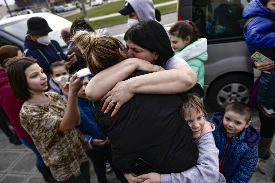 Ukrainian Irina Oscaria, 21 years, resident in Spain, hugs her mother Zhana Onishchenko after they arrived in Cizur Menor, northern Spain, Tuesday, March 15, 2022, after Russian's invasion of Ukraine. Oscaria's family traveled more than five thousands kilometers to arrive in Spain. (AP Photo/Alvaro Barrientos)