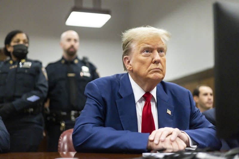 Former President Donald Trump waits for his criminal trial to begin at Manhattan Criminal Court in New York on Tuesday. Merchan gave Trump a $9,000 fine for his nine gag order violations. Pool Photo by Justin Lane/UPI