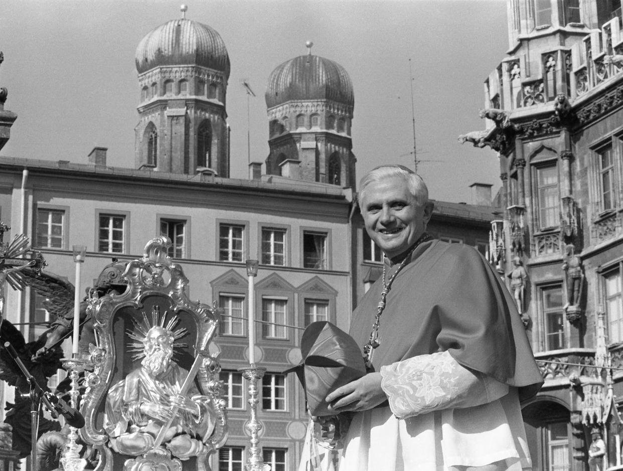 FILE - Cardinal Joseph Ratzinger, with the towers of Munich's cathedral in the background, bids farewell to Bavarian believers in downtown Munich, Germany, on Feb. 28, 1982, before heading to Rome to lead the Congregation for the Doctrine of the Faith at the Vatican. Cardinal Ratzinger went on to become Pope Benedict XVI. Pope Emeritus Benedict XVI, the German theologian who will be remembered as the first pope in 600 years to resign, has died, the Vatican announced Saturday. He was 95. (AP Photo/Dieter Endlicher, File)