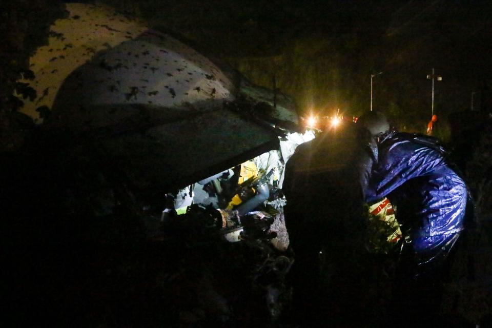 The wreckage of an Air India Express jet, which was carrying more than 190 passengers and crew from Dubai, is pictured after it crashed by overshooting the runway at Calicut International Airport in Karipur, Kerala, on August 7, 2020. - At least 14 people died and 15 others were critically injured when a passenger jet skidded off the runway after landing in heavy rain in India, police said on August 7. (Photo by Favas JALLA / AFP) (Photo by FAVAS JALLA/AFP via Getty Images)