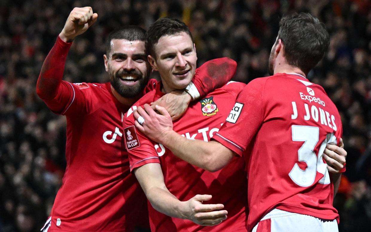 Wrexham's English striker Paul Mullin (C) celebrates scoring the team's third goal with Wrexham's English striker Elliot Lee - ‘You get used to the cameras – I’m loving Wrexham, it is the most exciting project in football’ - Getty Images/Oli Scarff