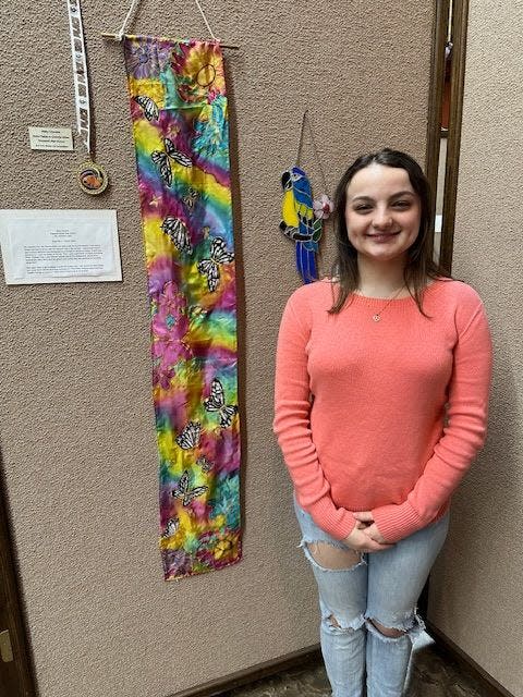 Abby Ciccone poses with her award-winning artwork "Gold Fields/Colorful Skies." Ciccone attends Hopewell Area High School.