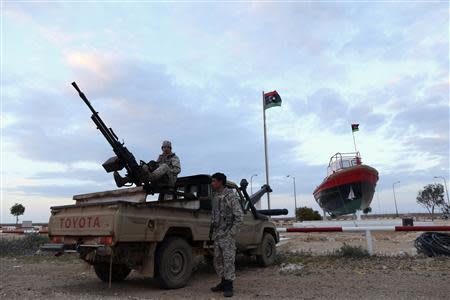 Rebels under Ibrahim Jathran, a former anti-Gaddafi rebel who seized the port and two others with thousands of his men in August, stand guard at the entrance of the Es Sider export terminal where a North Korean-flagged tanker has docked in Ras Lanuf March 8, 2014. REUTERS/Esam Omran Al-Fetori