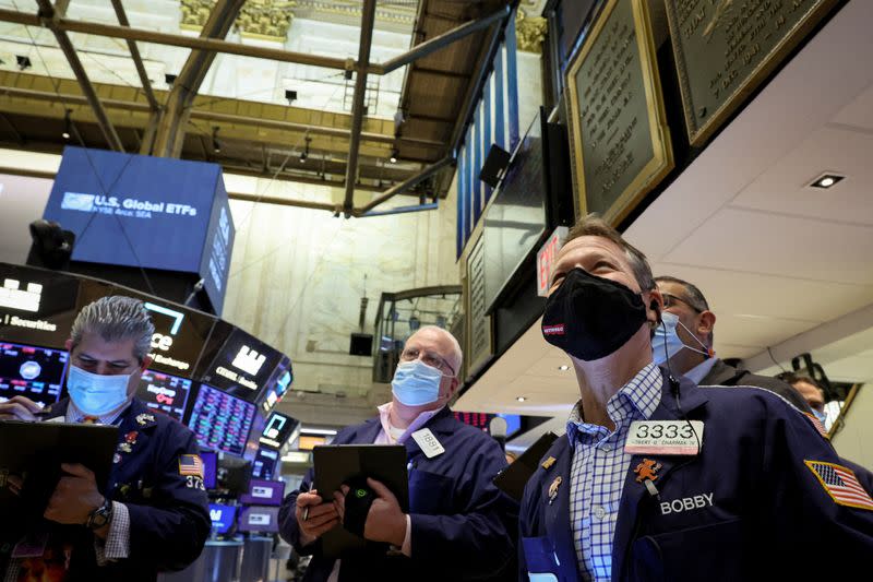 Traders work on the floor of the NYSE in New York