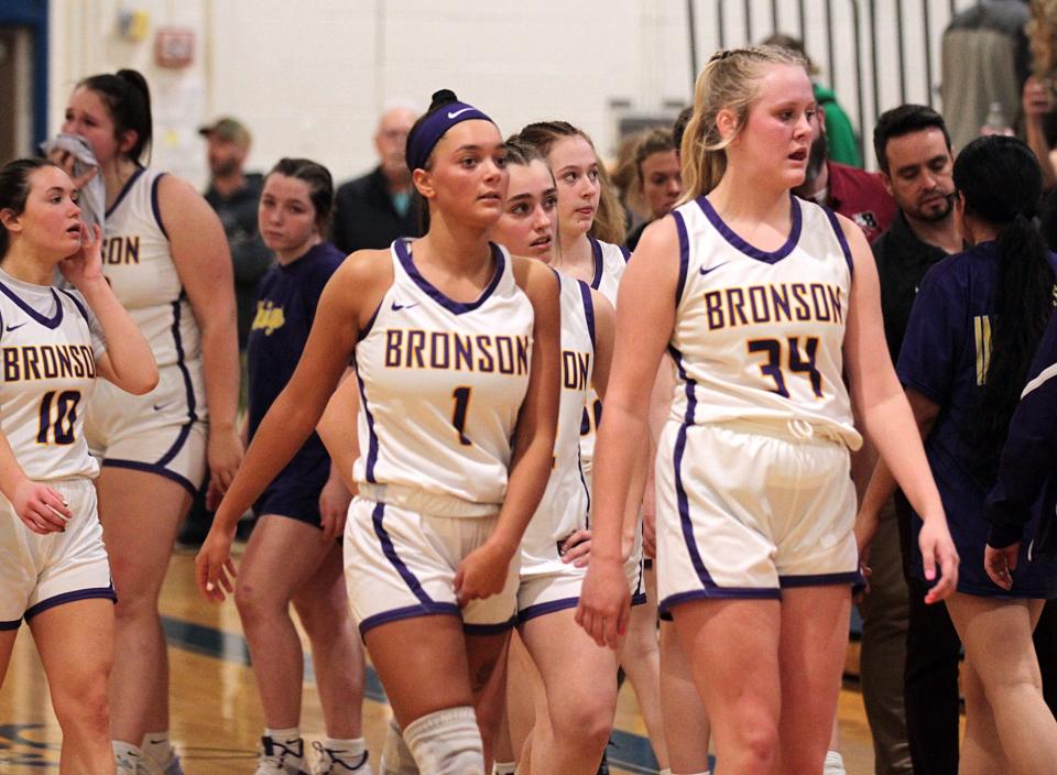 Bronson players exit the court following a loss to No. 1 Buchanan in the regional semifinals on Tuesday.