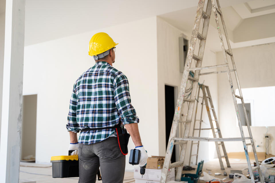 Electrician installing electrical wiring in a new residential project.