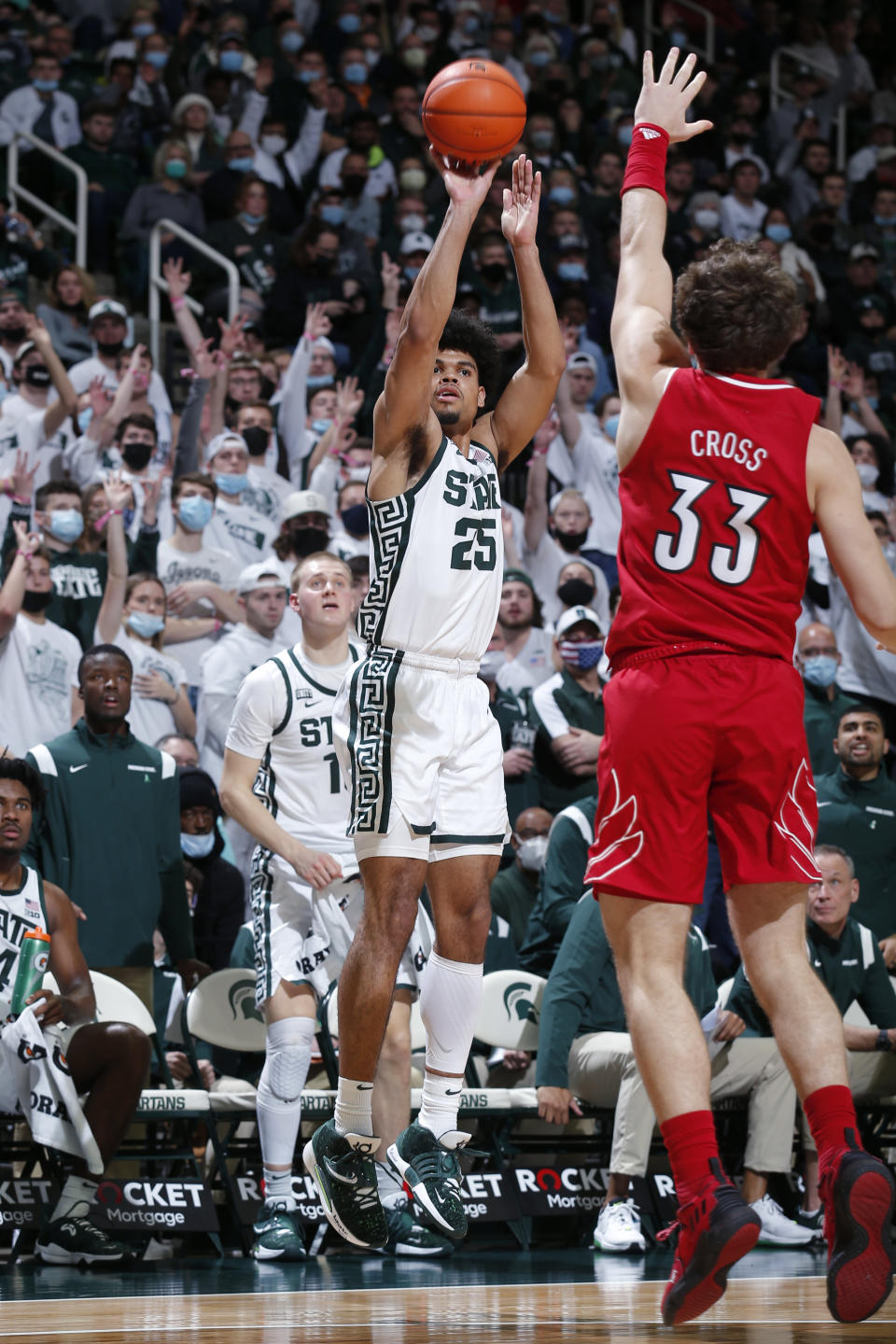 Michigan State's Malik Hall (25) shoots a 3-pointer against Louisville's Matt Cross (33) during the second half of an NCAA college basketball game Wednesday, Dec. 1, 2021, in East Lansing, Mich. (AP Photo/Al Goldis)