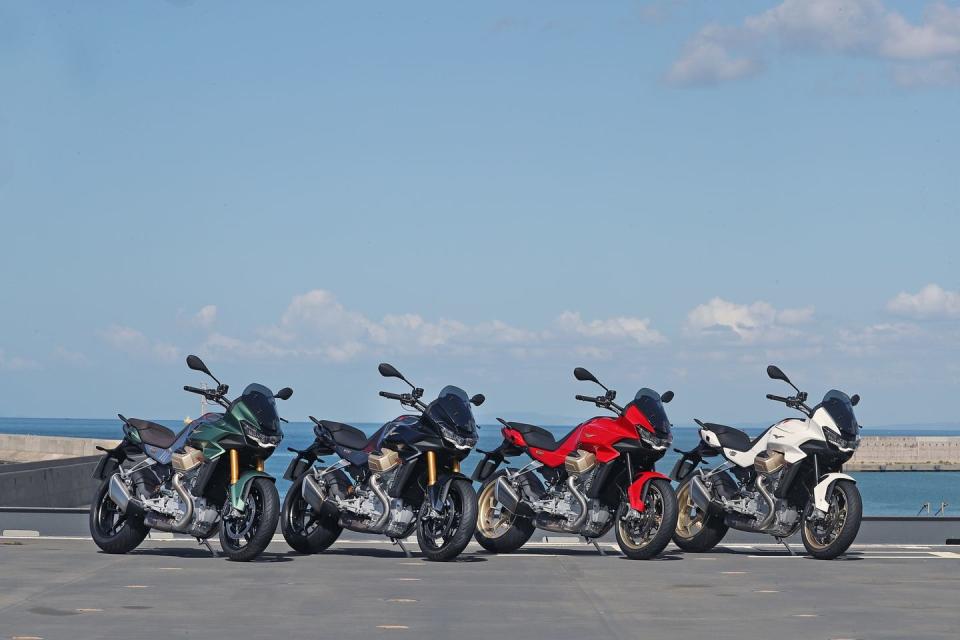 a group of motorcycles parked on the side of a road