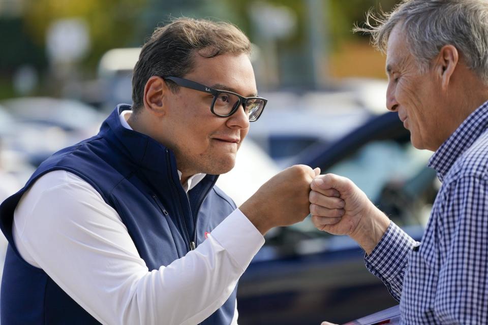 Republican candidate George Santos, left, fist-bumps campaign volunteer John Maccarone while campaigning on Nov. 5, 2022, in Glen Cove, N.Y. <a href="https://newsroom.ap.org/detail/Election2022NewYorkHouse/58045c130be64798a4eed98ed7a1e93c/photo?Query=George%20Santos%20campaigning&mediaType=photo&sortBy=arrivaldatetime:asc&dateRange=Anytime&totalCount=103&currentItemNo=4" rel="nofollow noopener" target="_blank" data-ylk="slk:AP Photo/Mary Altaffer;elm:context_link;itc:0;sec:content-canvas" class="link ">AP Photo/Mary Altaffer</a>