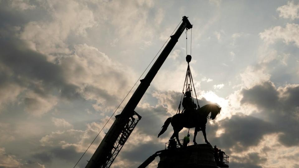 Crews work to remove one of the country's largest remaining monuments to the Confederacy, a towering statue of Confederate Gen. Robert E Lee on Monument Avenue, in Richmond, Virginia. (Copyright 2021 The Associated Press. All rights reserved)