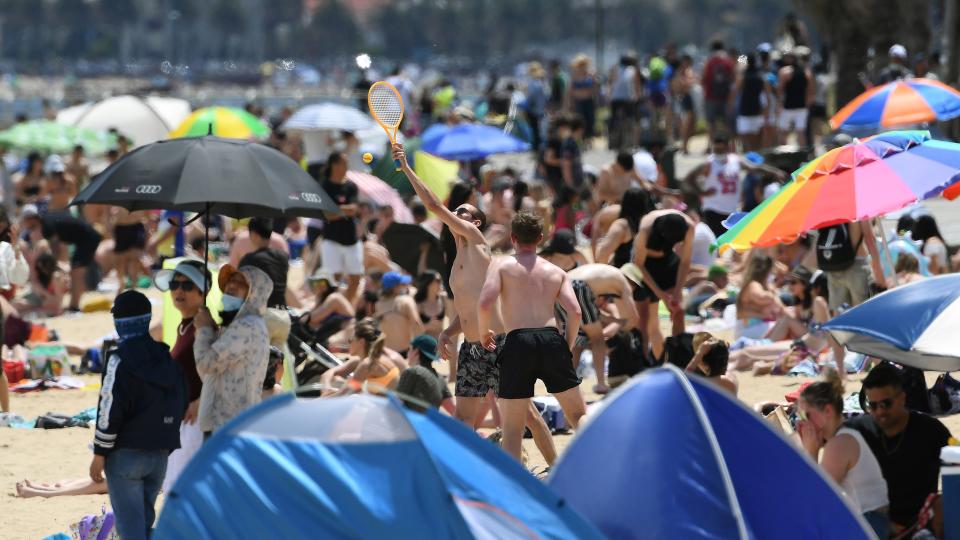People enjoy the warm weather on Melbourne's St Kilda Beach on November 3, 2020, as Australia's Victoria state records its fourth straight day of zero transmissions of the COVID-19 coronavirus after battling a second wave of infections. (Photo by William WEST / AFP) (Photo by WILLIAM WEST/AFP via Getty Images)