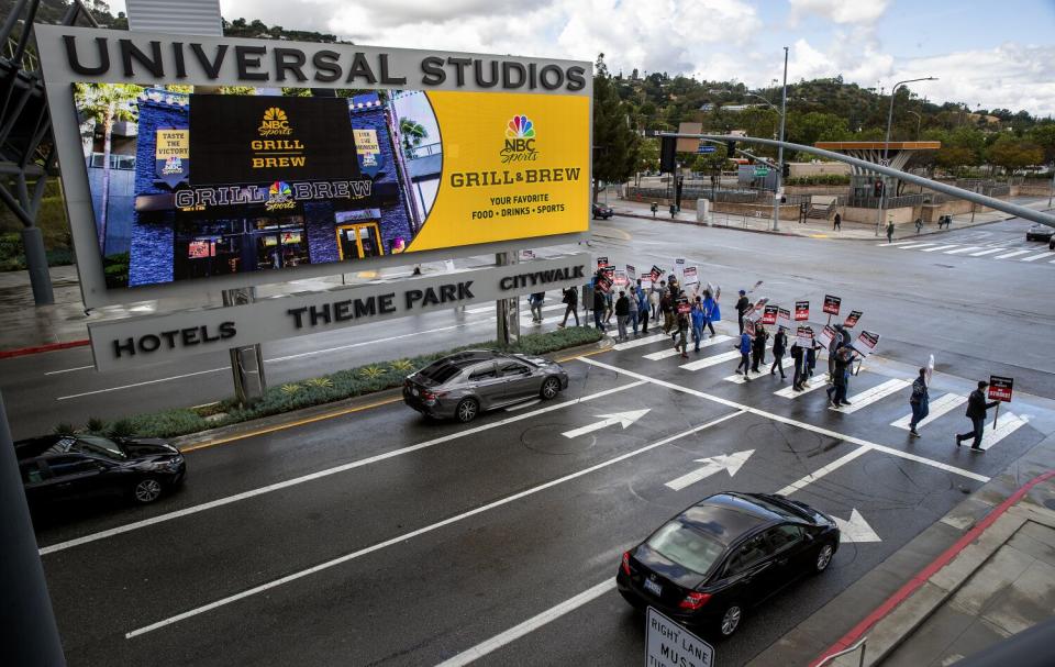 Members of the Writers Guild of America strike in front of NBCUniversal offices in Universal City.