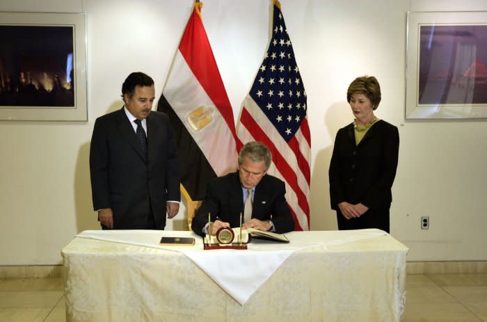 U.S. President George W. Bush (C) and first lady Laura visit the Egyptian Embassy and greet ambassador Nabil Fahmy (L) to sign a book of condolence for the weekend bombing in Egypt's Red Sea resort town of Sharm el-Sheik in Washington on July 25, 2005.  File Photo by Jay L. Clendenin/UPI