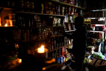A vendor waits for customers during a national blackout, in Buenos Aires