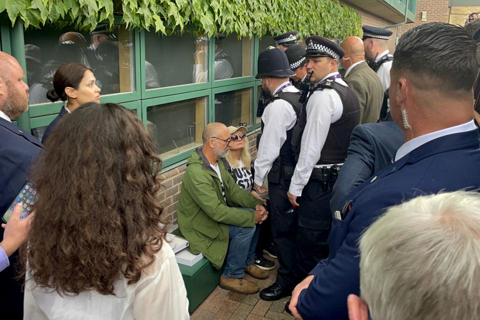 Just Stop Oil protesters are detained by police after throwing orange confetti on Court 18 (Jonathan Veal/PA) (PA Wire)