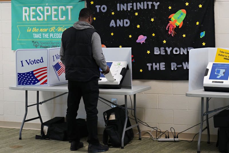 A voter casts a ballot in the Democratic presidential primary February 29 at the Dutch Fork High School in Irmo, S.C. On March 30, 1870, the 15th Amendment, granting African American men the right to vote, was adopted into the U.S. Constitution. File Photo by Richard Ellis/UPI