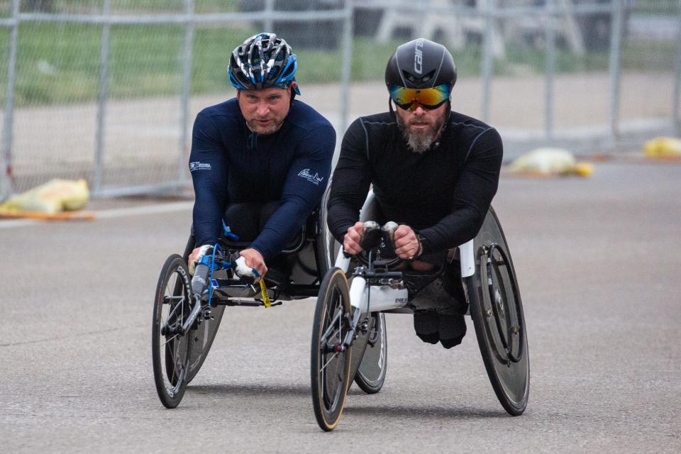Two wheelchair participants take part in the KDF Marathon and miniMarathon outside Churchill Downs on Apr. 29, 2023.