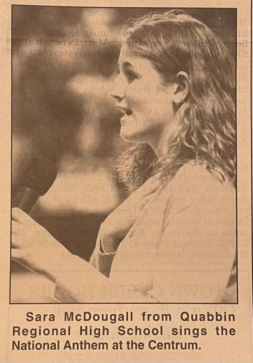 Sara McDougall sang the National Anthem at Quabbin's game against East Boston in the state finals in 1999. She sang once again at a game that celebrated the 1999 team and its members on February 2, 2024.