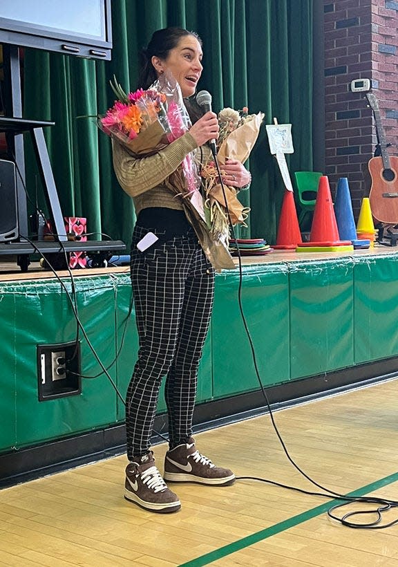 Meaghan Dunn, the Greater Dover Chamber of Commerce's 2023 David K. Bamford Educator of the Year, addresses students and staff at the Frances G. Hopkins Elementary School at Horne Street.