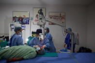 Nepal’s “God of Sight”, Dr. Sanduk Ruit performs a simple surgical technique to remove cataracts at an eye camp in Lumbini, 288 kilometers (180 miles) south west of Kathmandu, Nepal, March 31, 2021. The eye doctor renowned for his innovative and inexpensive cataract surgery for the poor is taking his work beyond the Himalayan mountains to other parts of the world so there is no more unnecessary blindness in the world. Ruit, who has won many awards for his work and performed some 130,000 cataract surgery in the past three decades, is aiming to expand his work beyond the borders of his home country and the region to go globally. (AP Photo/Bikram Rai)