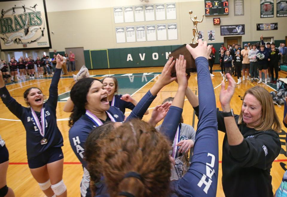 Harley Allendale Columbia players celebrate with the championship trophy after their Class D1 girls volleyball championship win over Letchworth Saturday, Nov. 5, 2022, at Avon High School.  HAC won the championship in straight sets, 3-0.  