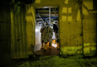 <p>An employee and journalists walk through the corridor of the stopped third reactor at the Chernobyl nuclear power plant in Chernobyl, Ukraine, April 20, 2018. (Photo: Gleb Garanich/Reuters) </p>