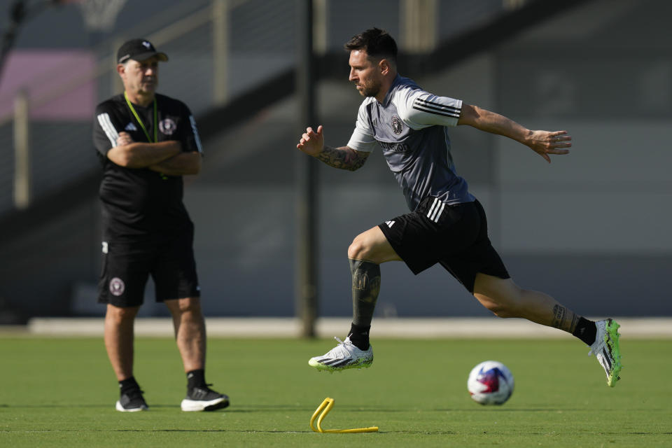 Lionel Messi, right, participates in a training session for the Inter Miami MLS soccer team as head coach Gerardo "Tata" Martino looks on, Tuesday, July 18, 2023, in Fort Lauderdale, Fla.(AP Photo/Rebecca Blackwell)