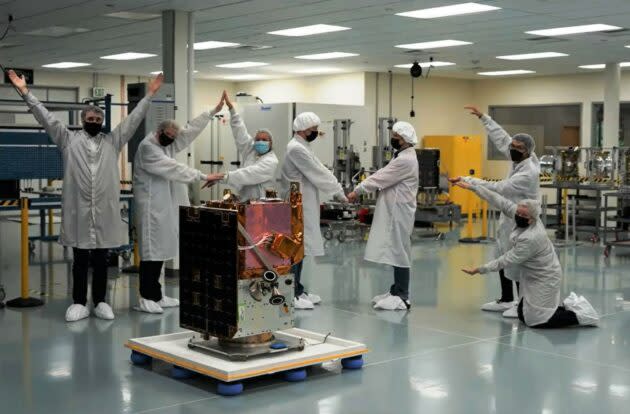 Clean-room workers with satellite