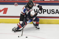 United States' Kendall Coyne Schofield is pressured by Canada's Natalie Spooner, top, during the first period of a women's hockey game in a pre-Olympic Games series Monday, Oct. 25, 2021, in Hartford, Conn. (AP Photo/Jessica Hill)