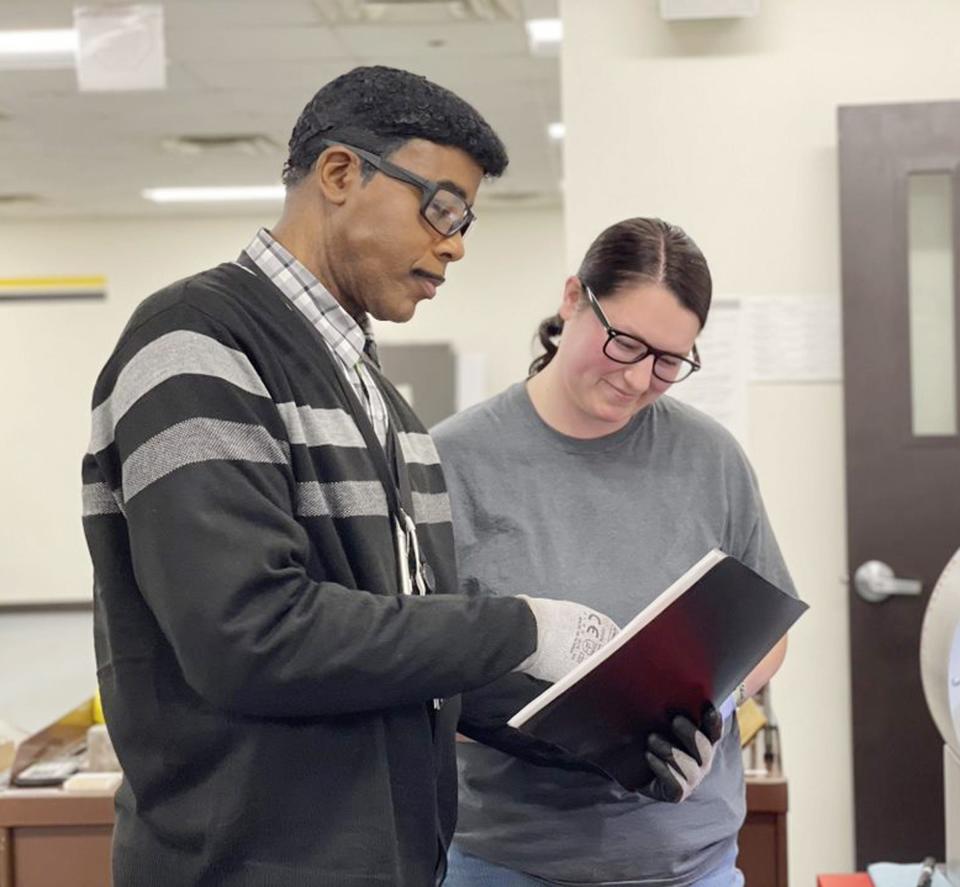 Darrell Burkes works with Brittany Smith on machining training at Caterpillar in Pontiac. A machinist trainee is one of the positions currently available.
