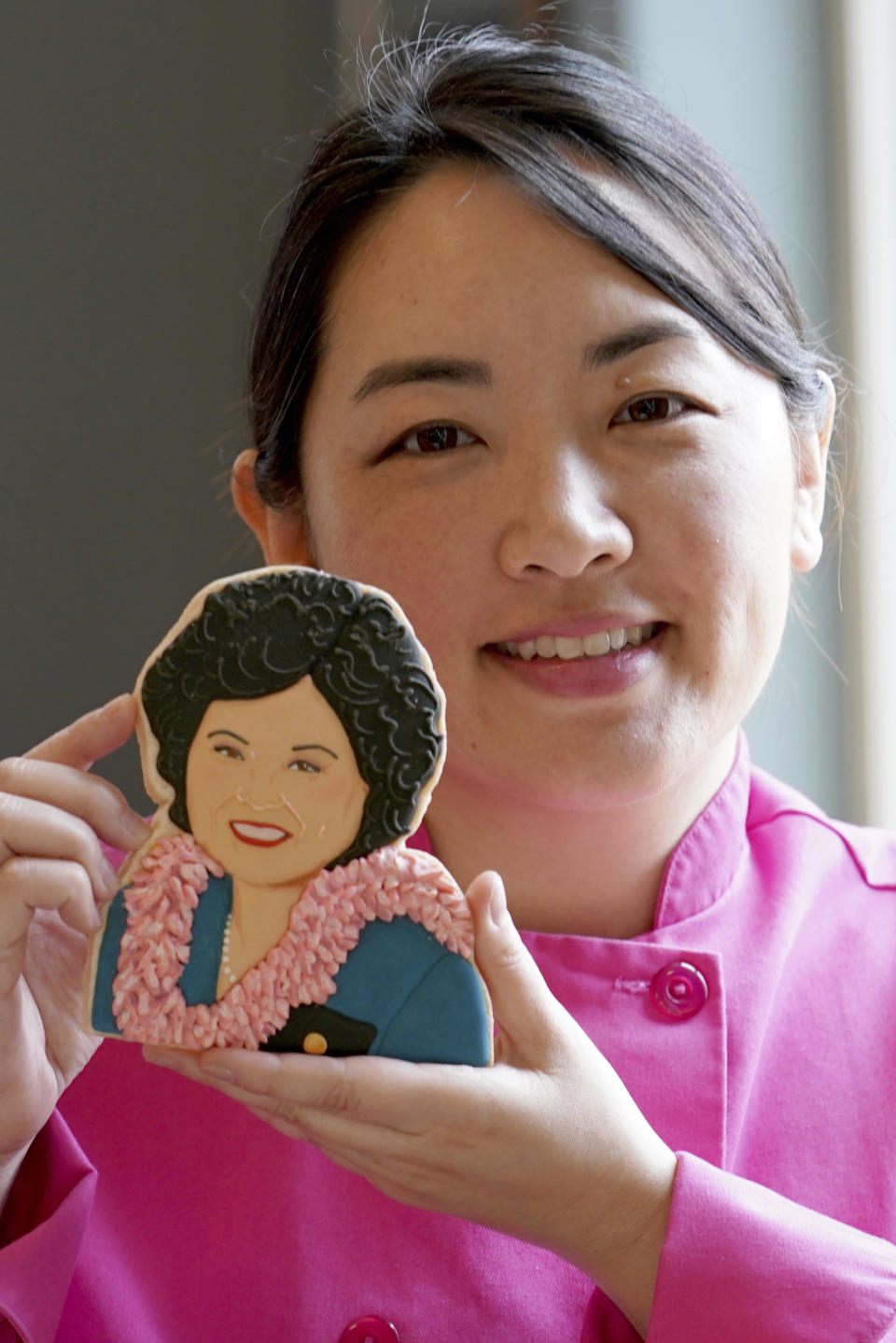 Jasmine Cho holds a cookie portrait of late Hawaii Rep. Patsy Takemoto Mink, the first Asian-American woman to serve in Congress, in Pittsburgh, Pa., Wednesday, May 3, 2023. Cho, a Korean American self-described “cookie activist,” has gained fans over the last several years for her finely detailed cookie mugs of famous and forgotten figures. (AP Photo/Matt Freed)