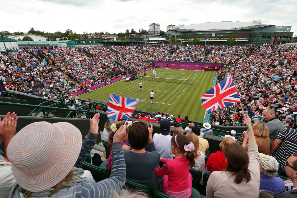 LONDON, ENGLAND - JULY 28: Fans cheer as Andy Murray and Jamie Murray of Great Britain play against Alexander Peya and Jurgen Melzer of Austria during their Men's Doubles Tennis match on Day 1 of the London 2012 Olympic Games at the All England Lawn Tennis and Croquet Club in Wimbledon on July 28, 2012 in London, England. (Photo by Clive Brunskill/Getty Images)