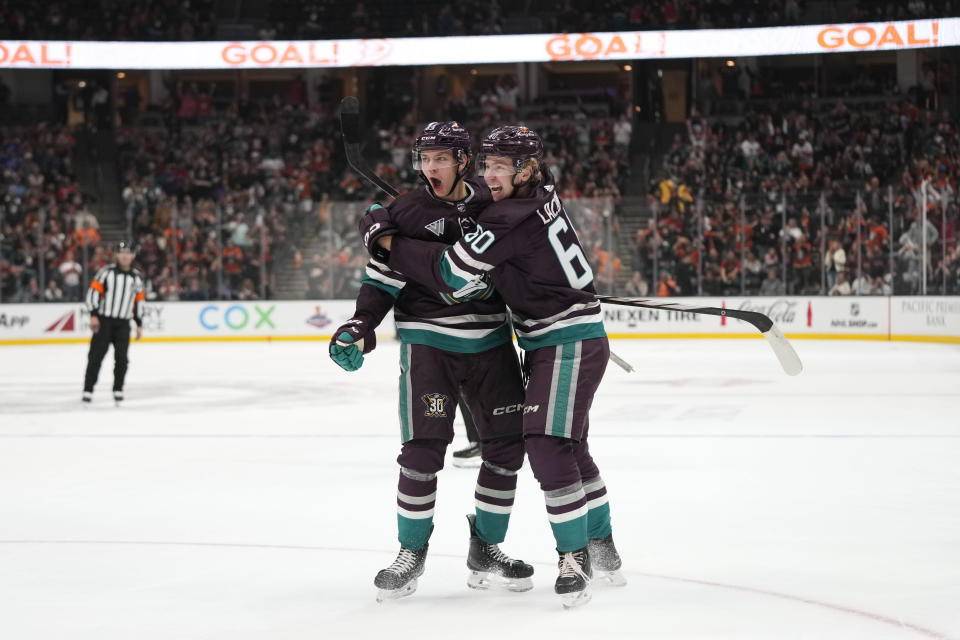 Anaheim Ducks' Pavel Mintyukov celebrates his goal with Jackson LaCombe during the first period of an NHL hockey game against the Carolina Hurricanes, Sunday, Oct. 15, 2023, in Anaheim, Calif. (AP Photo/Jae C. Hong)