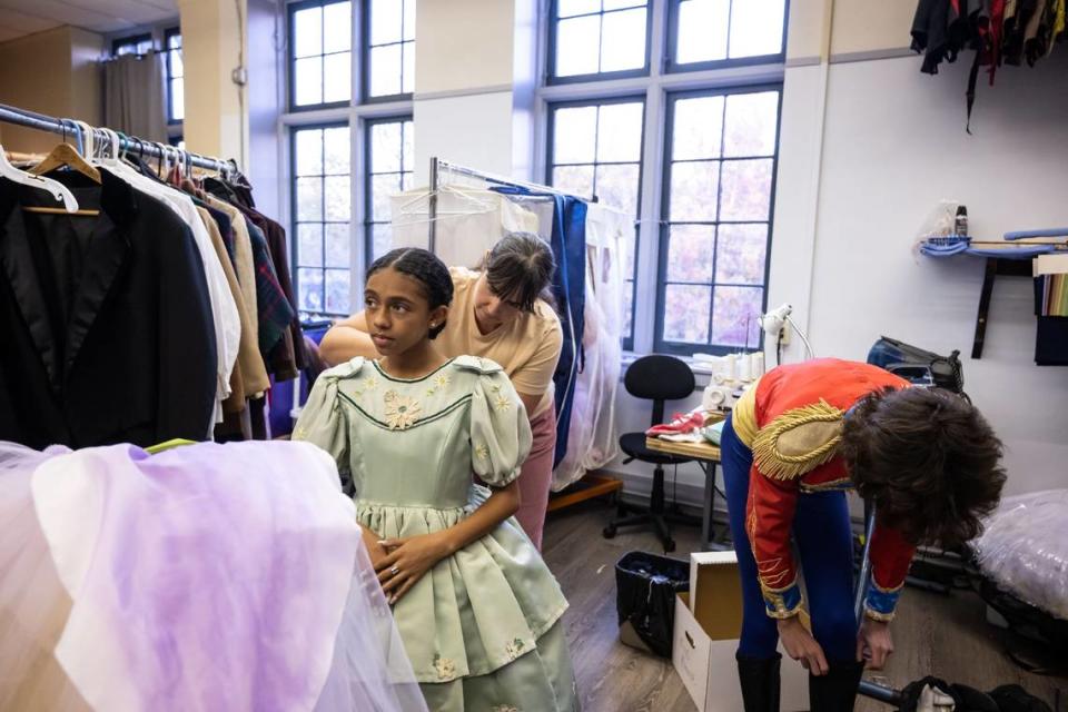 Dancer Taraji, 12, left, is fitted Tuesday as a “party girl” character by Zandra Manner, head of wardrobe. “Most of the roles, like party girl and party boy, involve a lot of acting, and I like acting,” Taraji said.