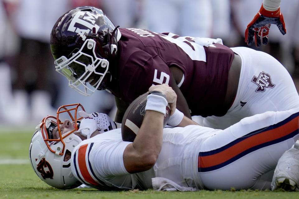 Texas A&M linebacker Edgerrin Cooper (45) gets in the face of Auburn quarterback Payton Thorne (1) after his is stopped short on a run Saturday, Sept. 23, 2023, in College Station, Texas. (AP Photo/Sam Craft)