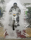 An army soldier rides through a wall of glass tubes during a ceremony at the Officers Training Academy in Chennai March 19, 2010. REUTERS/Babu