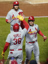 St. Louis Cardinals' Juan Yepez (36) greets Lars Nootbaar, center, and Brendan Donovan, top after they scored on a hit by Albert Pujols during the third inning of the team's baseball game against the Pittsburgh Pirates, Tuesday, Oct. 4, 2022, in Pittsburgh. (AP Photo/Keith Srakocic)