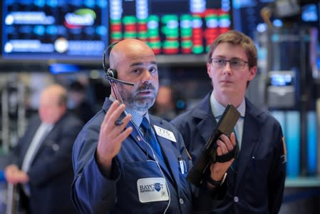 Traders work on the floor at the NYSE in New York