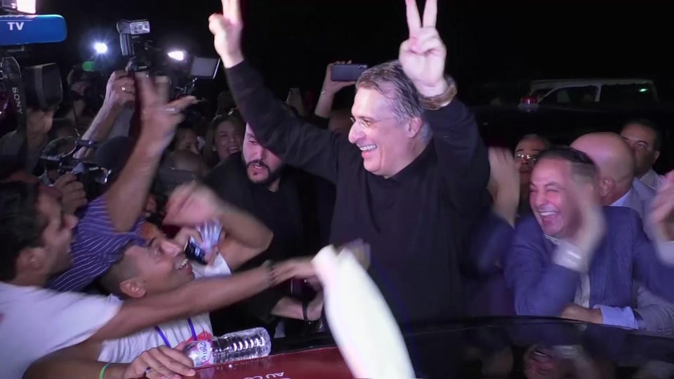 In this image from TV, jubilant crowds greet Tunisian presidential candidate and media mogul Nabil Karoui, centre, after he was released from prison in Mannouba, Tunisia, Wednesday Oct. 9, 2019, just four days before the upcoming presidential runoff election. Karoui has been jailed since August under investigation for alleged money laundering and tax fraud that he asserts as a politically motivated smear campaign. (AP Photo)