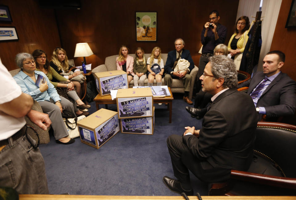 Assemblyman Richard Bloom, D-Santa Monica, seated second from right, meets with supporters of his measure that bans holding killer whales for performance and entertainment purposes, Monday, April 7, 2014, at the Capitol in Sacramento, Calif. Supporters of the bill, AB2140 criticize the negative aspects of captive orcas at Sea World. The bill goes before the Assembly Water, Parks and Wildlife Committee Tuesday.(AP Photo/Rich Pedroncelli)